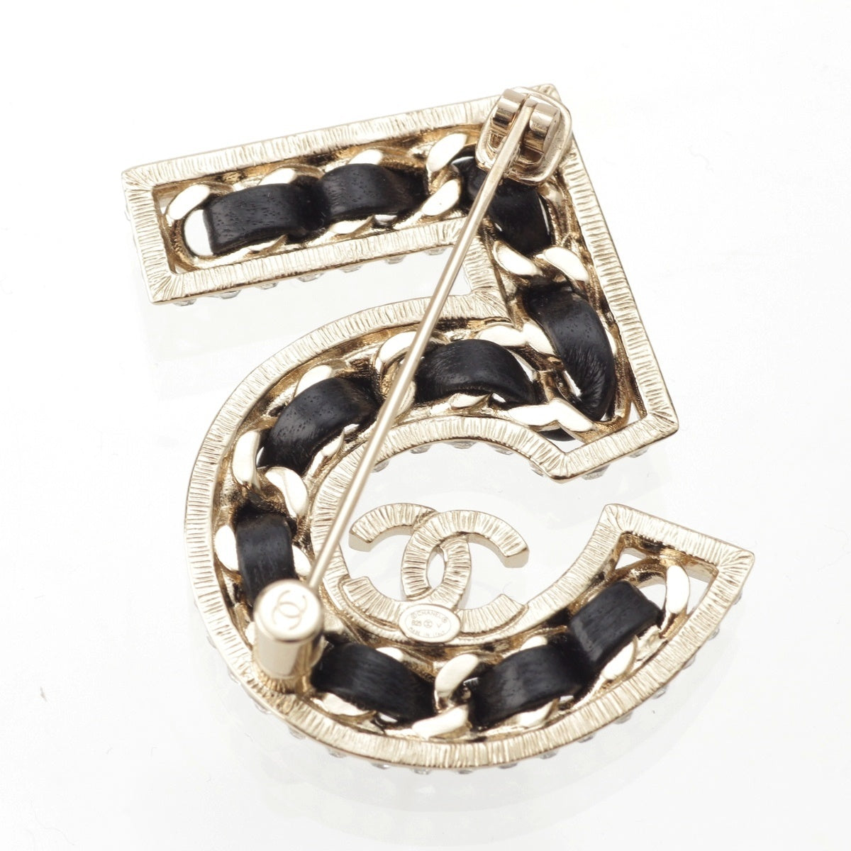CHANEL Leather with rhinestones, gold plated. No.5 Brooch Accessories Black Champagne Gold