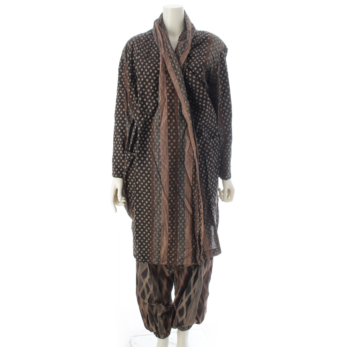ISSEY MIYAKE All-over pattern, irregularly shaped ikat fabric, shoulder pads, draped skort, docking. Pants setup Brown 9